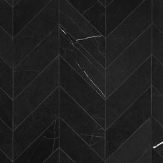 black marble chevron pattern with white veining on the edges and diagonal lines that lead up to the floor