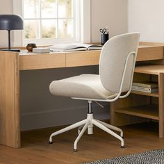 a white office chair sitting in front of a desk