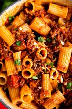 a bowl filled with pasta and meat sauce