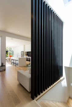 a living room filled with furniture next to a wooden floor