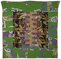 a green and black quilt with an animal on it