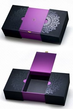 two black boxes with purple designs on the sides and one has an open box in the middle