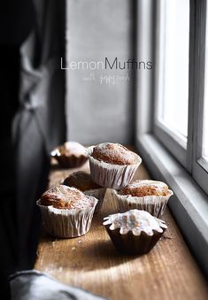 some muffins are sitting on a table by a window