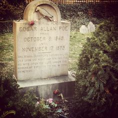 the headstone of edgar allen poe is surrounded by greenery