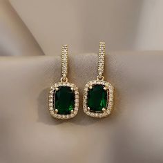 * New Emerald Green Crystal Elegant Square Gold Cubic Zirconia Diamond Earrings * Boutique Item * Unique, Delicate, And Trendy * Color: Gold * High Quality Materials And Premium Plating Process * All Jewelry Items Come With A Cleaning / Ponishing Cloth * Bundle And Save! Other Listings: Silver Gold Pearl Necklace Earrings Bracelet Engagement Ring, 925 Sterling Silver, S925 Silver, Vintage Style, Modern, Punk, Chunky, Minimal, Simple, Classic, Trendy, 925 Gold Ring, Adjustable Open Ring, Cute, Ch Emerald Earrings Drop, Art Deco Earrings, Emerald Earrings, Crystal Drop Earrings, Diamond Drops, Diamond Drop Earrings, Rhinestone Earrings, Green Crystals, Pearl Drop Earrings