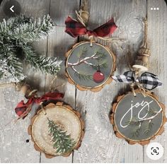 three christmas ornaments are hanging on wooden boards