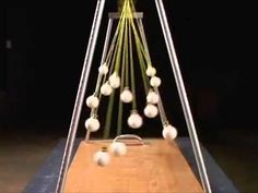 a wooden table topped with lots of white balls on top of a piece of wood