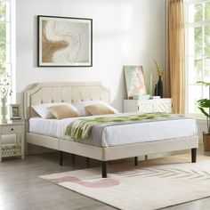 a bedroom with a bed, dressers and window in it's center area