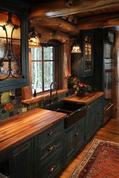 a kitchen with green cabinets and wooden counter tops in front of a window that looks out onto the woods