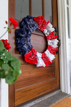 a red, white and blue wreath on the front door