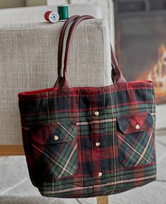 a red and green plaid purse sitting on top of a chair