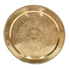 a gold plate with intricate designs on it