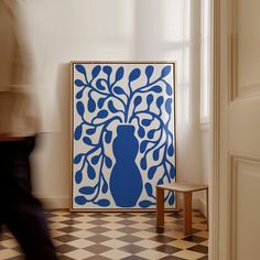 a blue and white painting sitting on top of a black and white checkered floor