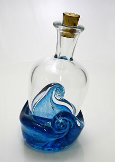 a glass bottle with a blue wave in it