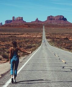 a woman walking down the middle of an empty road with mountains in the background and text that reads difficult roads often lead to beautiful destinations