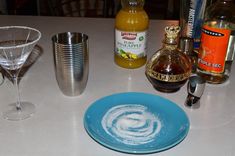 a table topped with glasses and bottles of alcohol