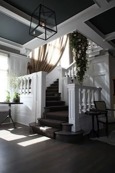 the stairs are decorated with flowers and greenery