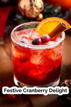 a festive cranberry delight cocktail with orange slice and cinnamon garnish