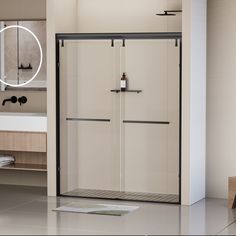 a bathroom with a walk in shower next to a white sink and mirror on the wall