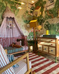 a child's bedroom with a canopy bed, dresser and crib in it