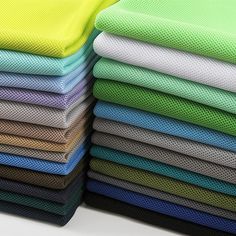 a stack of different colored cloths sitting on top of each other