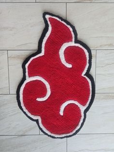 a red and black door mat with the letter s on it