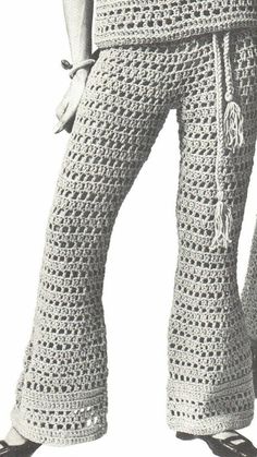 a woman wearing crocheted pants and sandals