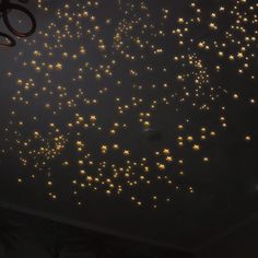 the ceiling is decorated with gold stars and lights in different shapes, sizes and colors