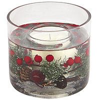 a clear glass candle holder filled with christmas decorations