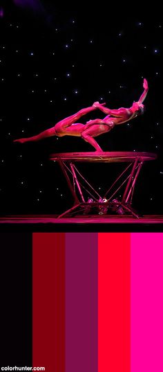 a woman is performing on a balance beam in front of a star filled night sky