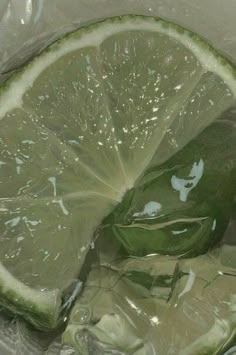 a sliced lime in a plastic bag with water on it's side and some ice