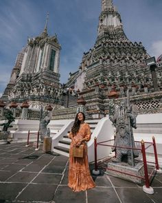 a woman standing in front of an ornate building