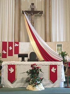 the altar is decorated with red and white banners