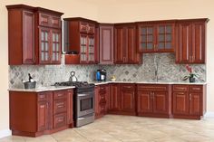 a kitchen with wooden cabinets and marble counter tops