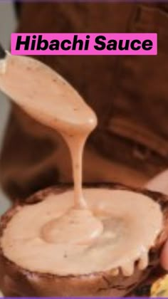 a person pouring peanut butter onto a piece of bread