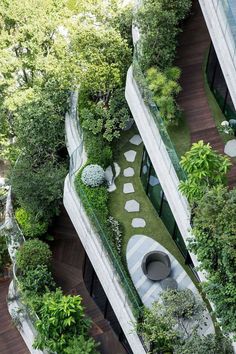 an aerial view of a building with trees and plants