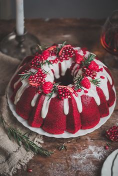 a red velvet bundt cake with white icing and berries