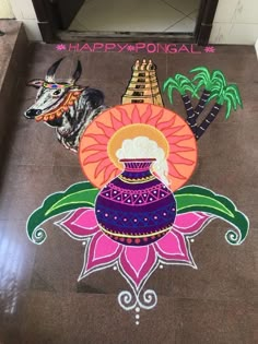 an artistic design on the floor in front of a sign that says happy pongal