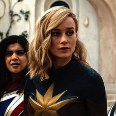 two women in costume standing next to each other on the set of captain marvel 2