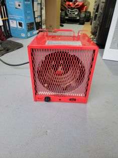 a red box fan sitting on top of a table