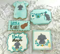 four decorated cookies with baby elephants on them and the words little peanut, baby shower