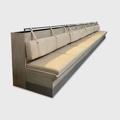 a long bench with several bags hanging from it's backrests and on the side