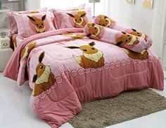 a bed with pink comforter and pillows on it