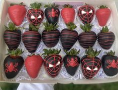 chocolate covered strawberries in a box with spider web decorations on the top and bottom