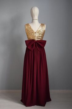 a dress with gold sequins and a red bow