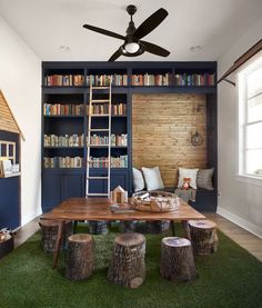 a living room filled with furniture and bookshelves next to a green carpeted floor