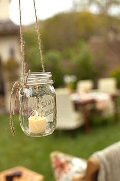 a mason jar with a candle hanging from it