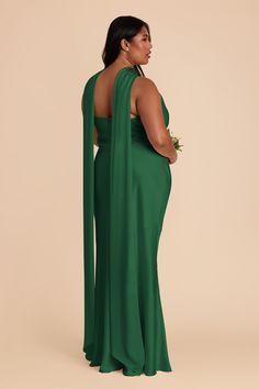 a woman in a green dress with her back to the camera