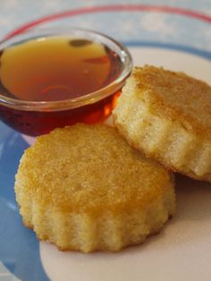 two fried food items on a plate with dipping sauce