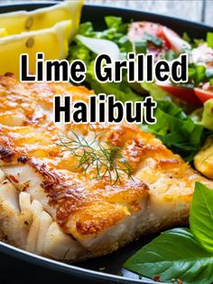 grilled halibut in a pan with salad and lemon wedges on the side